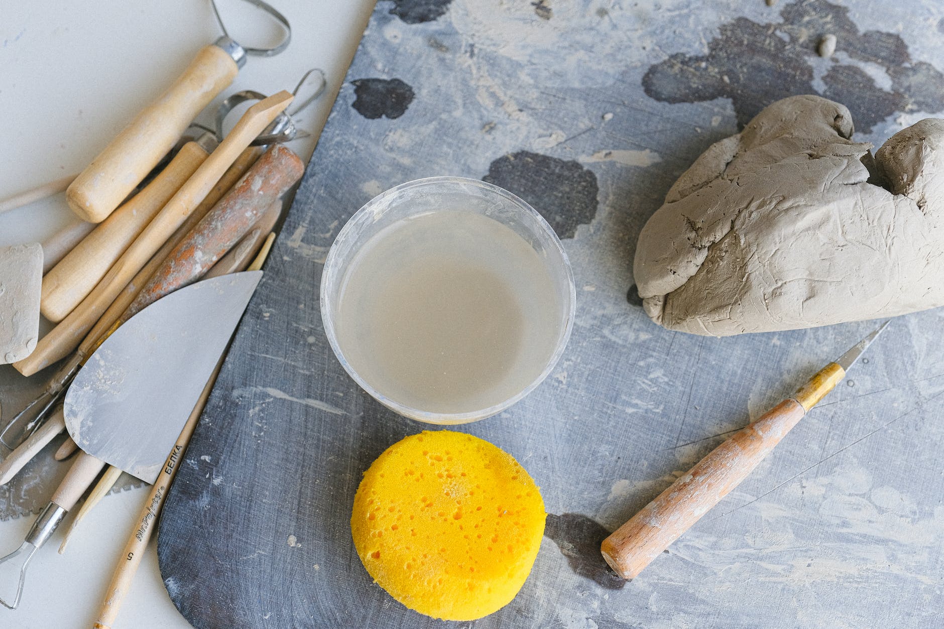 tools and bowl of water prepared for clay modeling